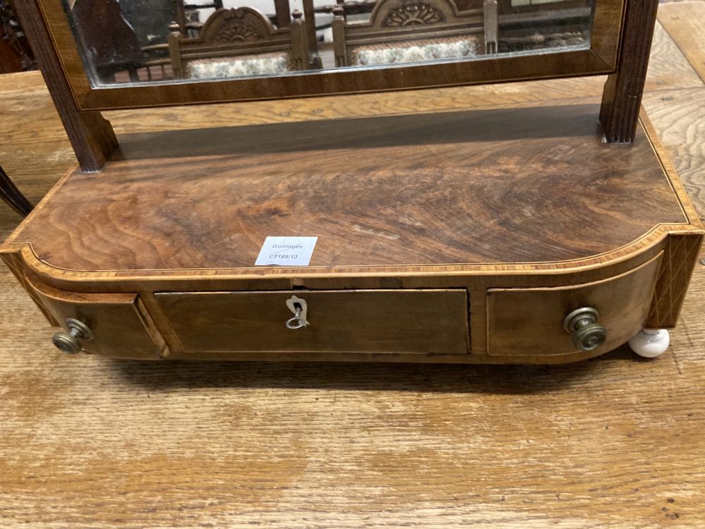A George III mahogany and tulipwood banded bowfronted toilet mirror, on ivory ball feet, width 54cm depth 23cm height 60cm